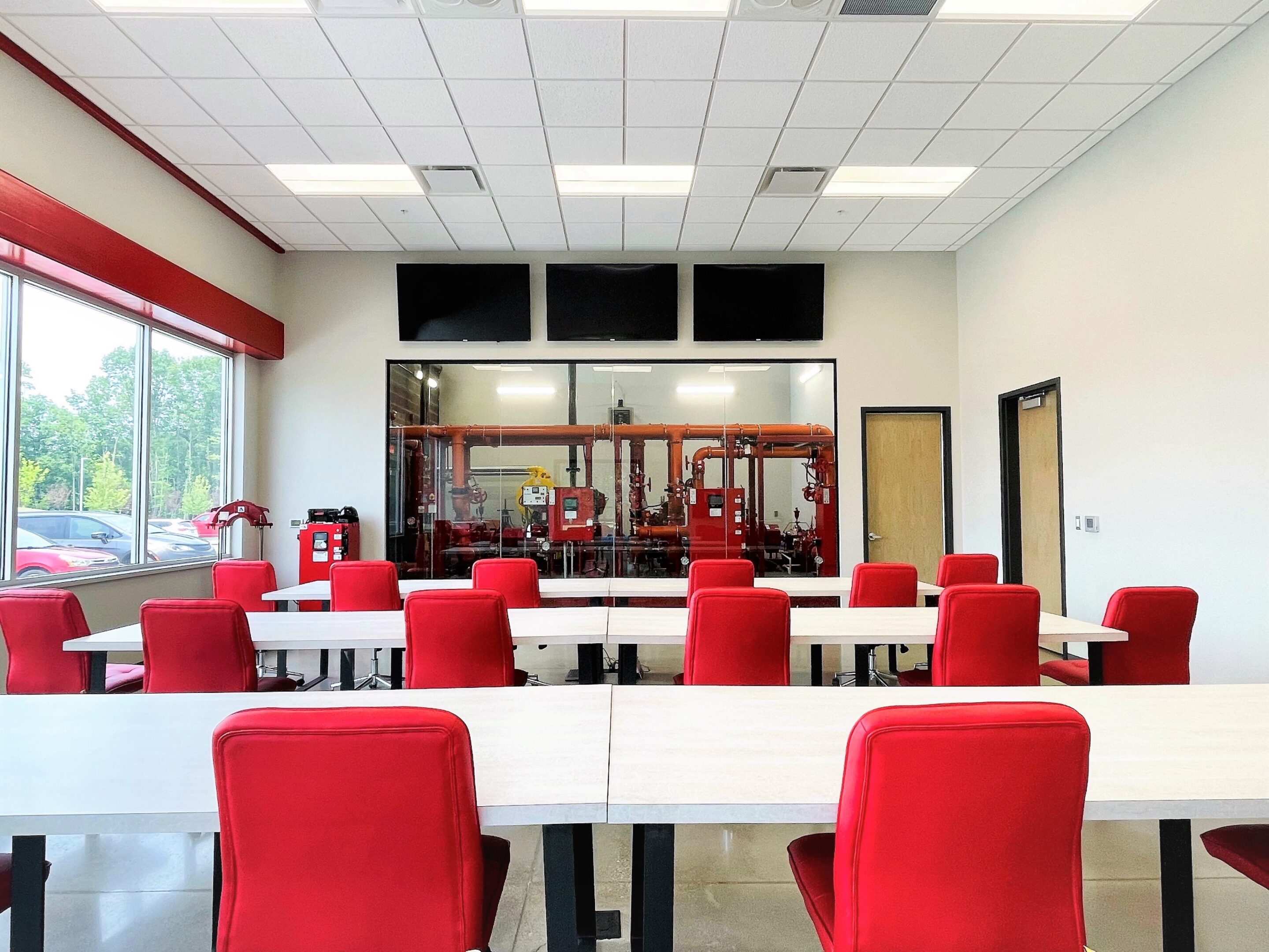 Lab 2 A room with red chairs and tables in it