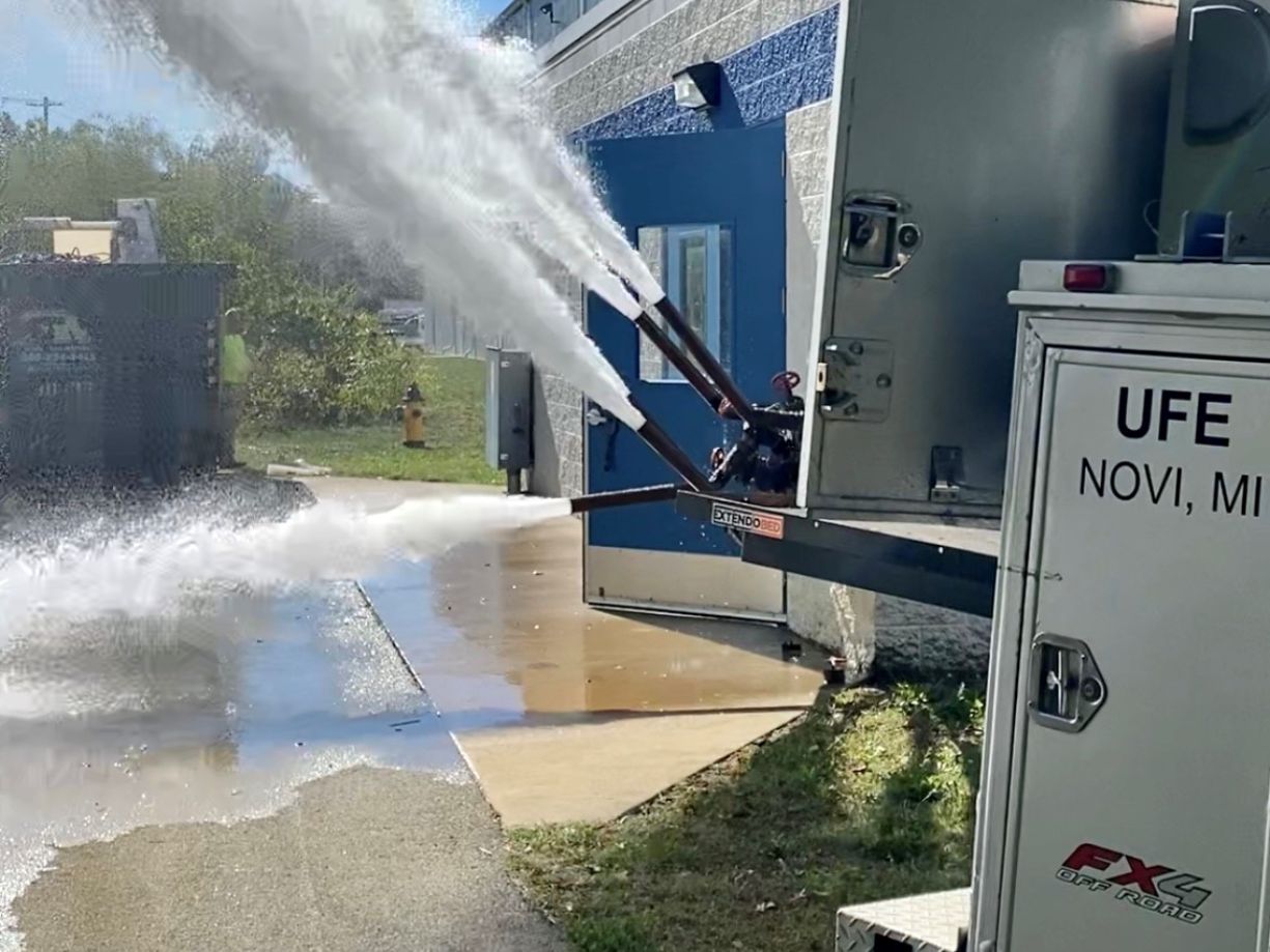 67eac788c445e_annual test (1) A fire truck spraying water on the ground.