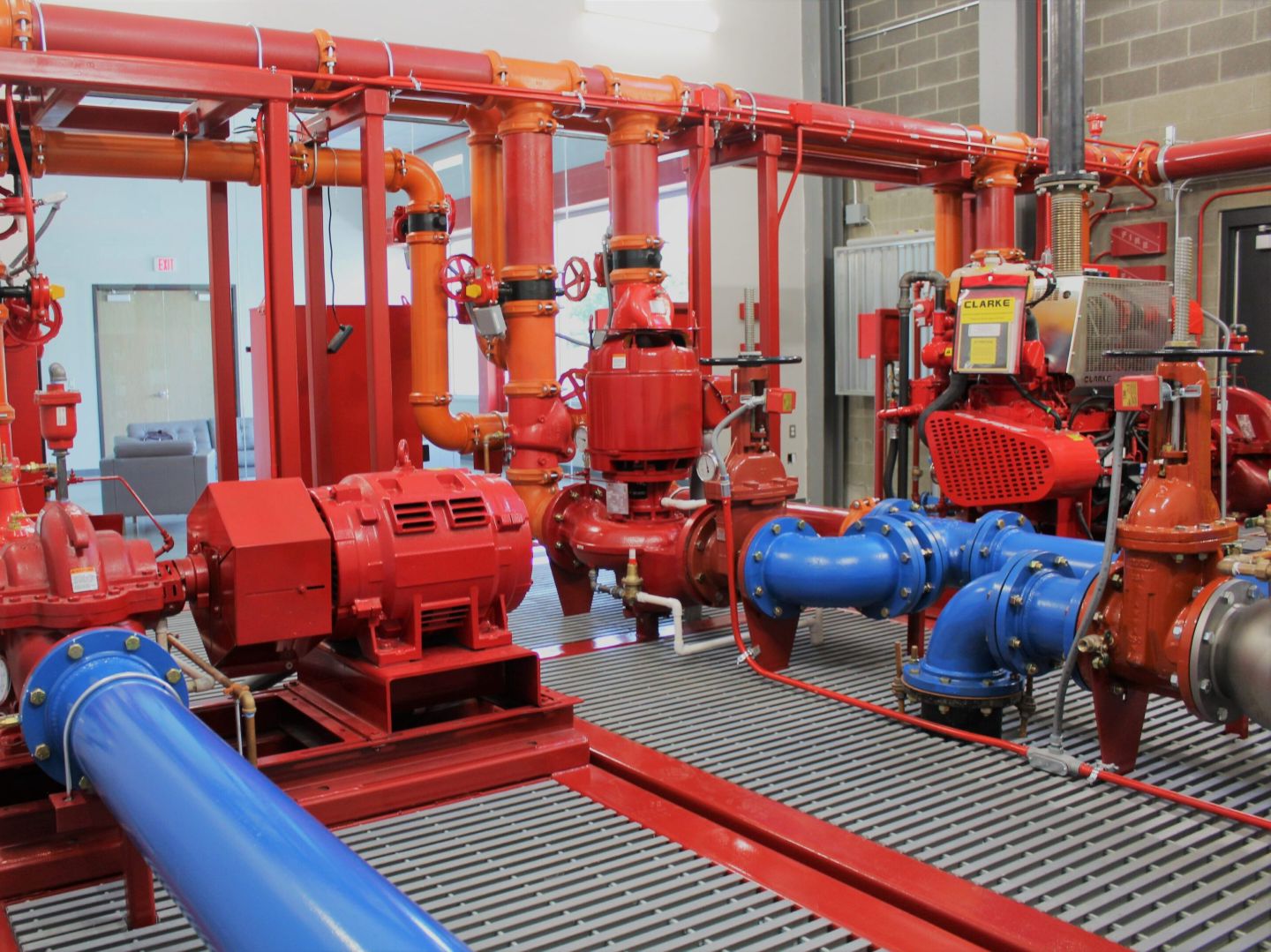 A red and blue fire hydrant is in the middle of a room.