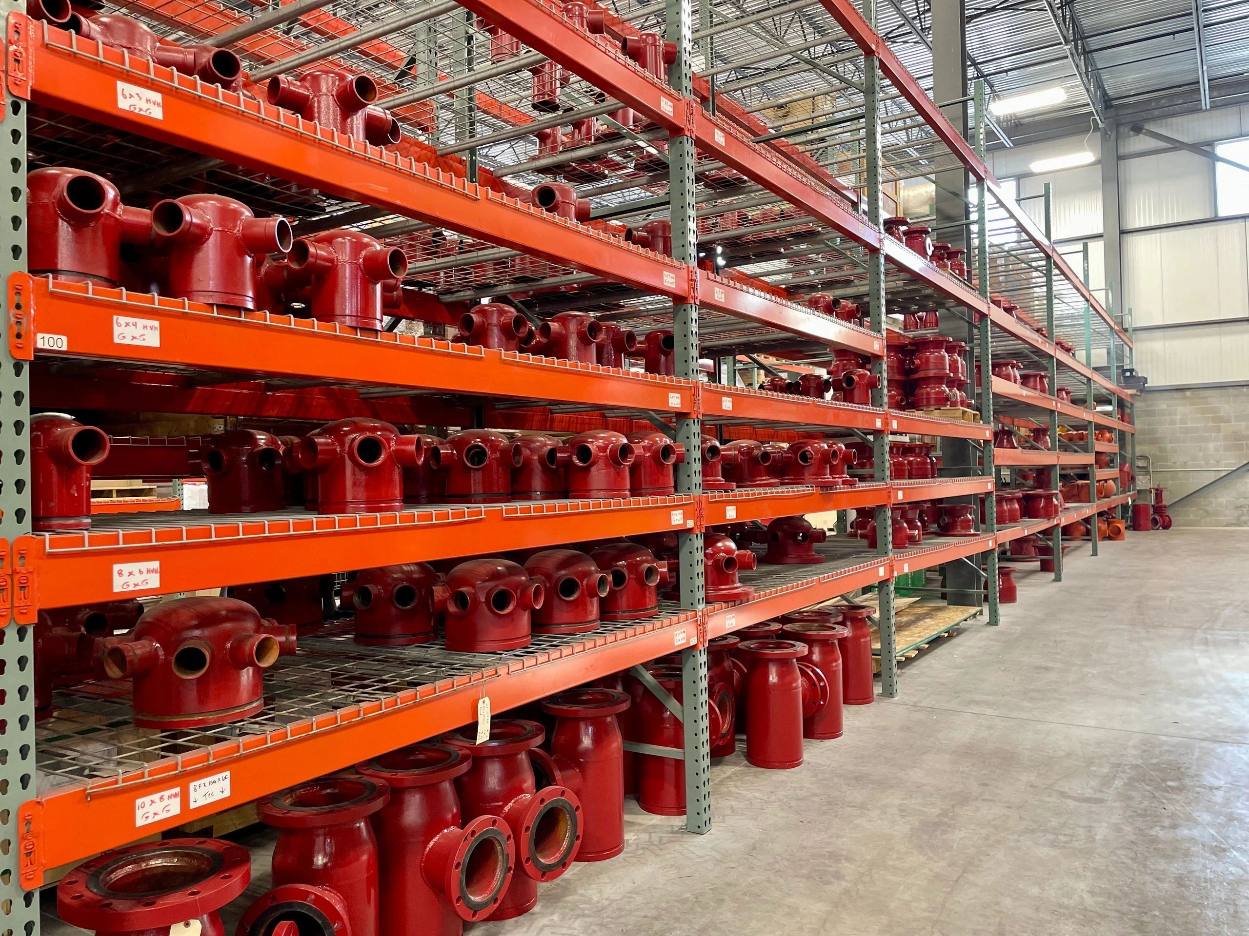 - A warehouse filled with lots of red pipes.