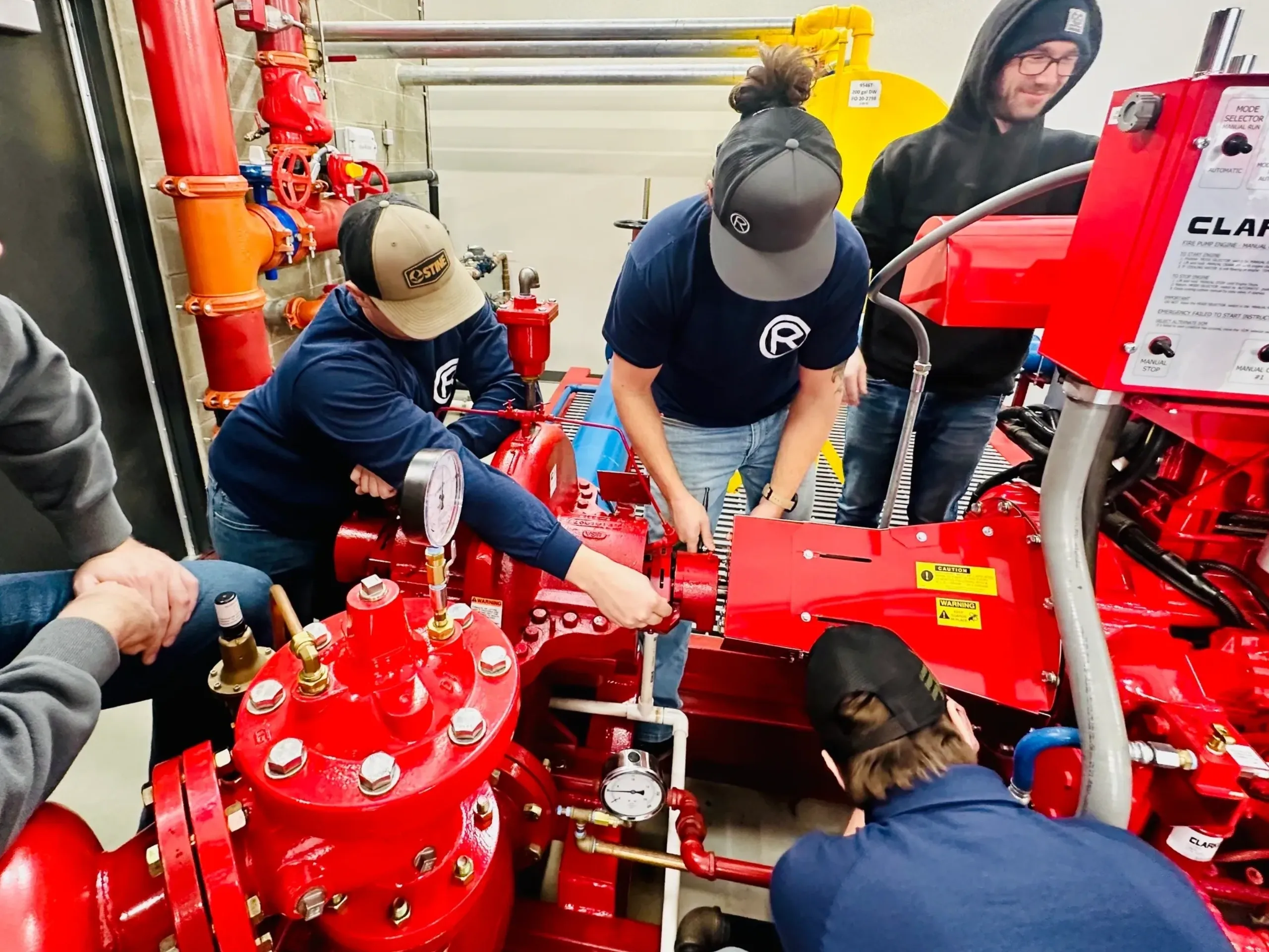 A group of people working on fire hydrant.